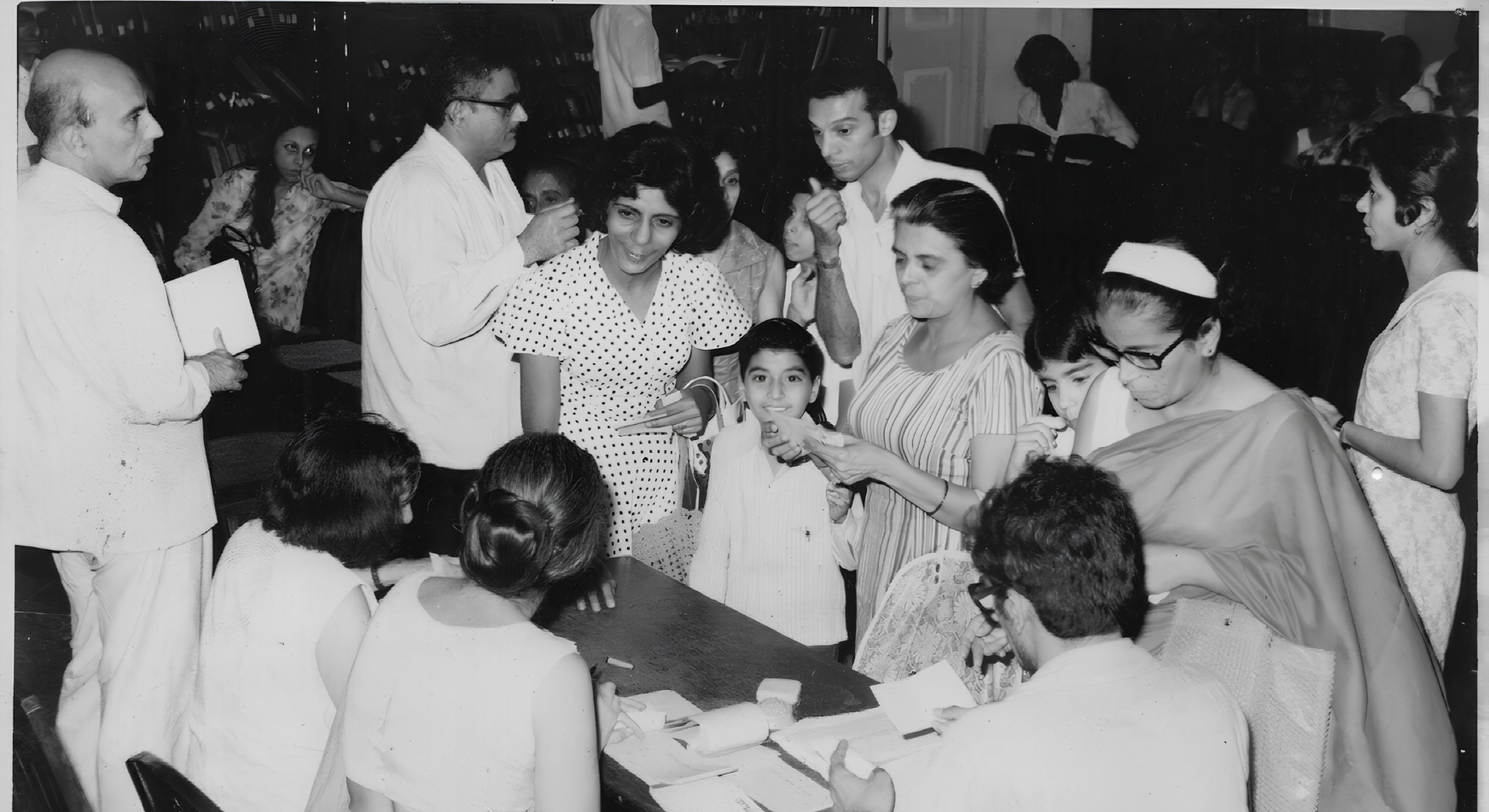 Volunteers and families registering children for TOS educational sponsorship grants