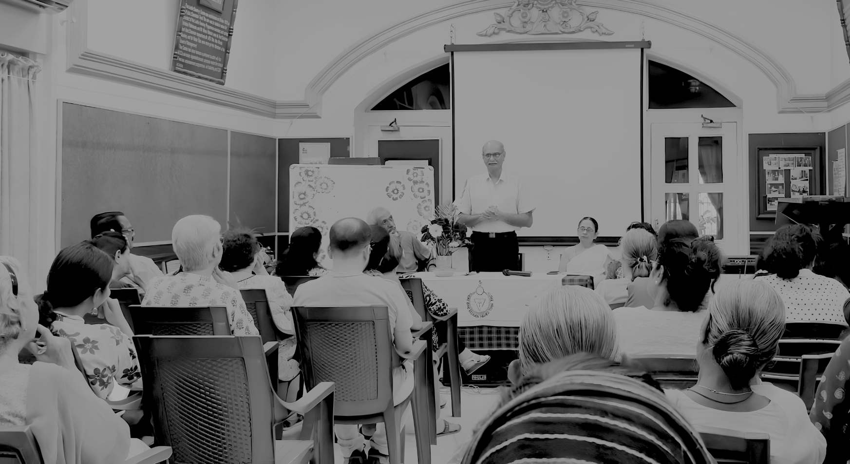 Delegates seated in a hall listening to a speaker at the TOS Annual Colloquium